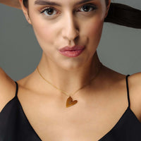 Thumbnail for Romantic Initial Necklace worn by a woman, showcasing a gold heart pendant for timeless elegance by Brother & Sisters.