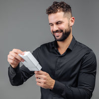Thumbnail for Man in black shirt joyfully unboxing Minimalist Photo Bracelet from Brother & Sisters.