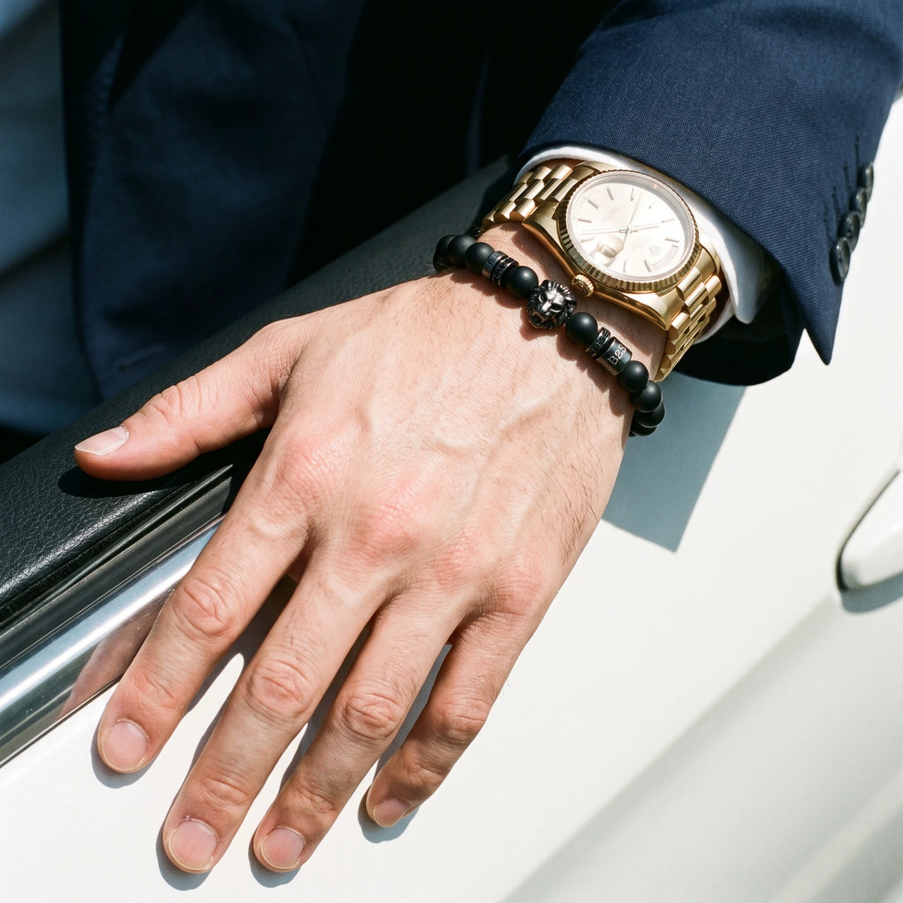 Black Lion & Black Stones Bracelet – worn next to a luxury watch | Brother & Sisters | SKU: 20712286-gun-black-XS-14-15, 20712286-gun-black-S-16-17, 20712286-gun-black-M-18-19, 20712286-gun-black-L-20-21, 20712286-gun-black-XL-22-23