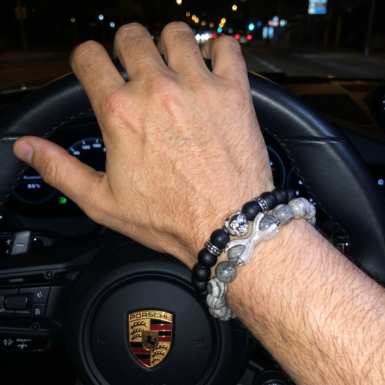 White Gold Lion with Black & Grey Stones Set – on a Porsche steering wheel at night | Brother & Sisters | SKU: 21369621-silver-XS-14-15, 21369621-silver-S-16-17, 21369621-silver-M-18-19, 21369621-silver-L-20-21, 21369621-silver-XL-22-23
